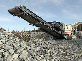 Mobile crusher with rock pile